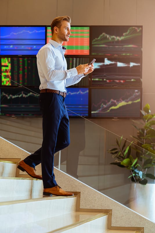 successful-smart-caucasian-businessman-walking-stair-trade-stock-with-smartphone-communicate-with-happiness-enthusiastic-modern-office-background-1