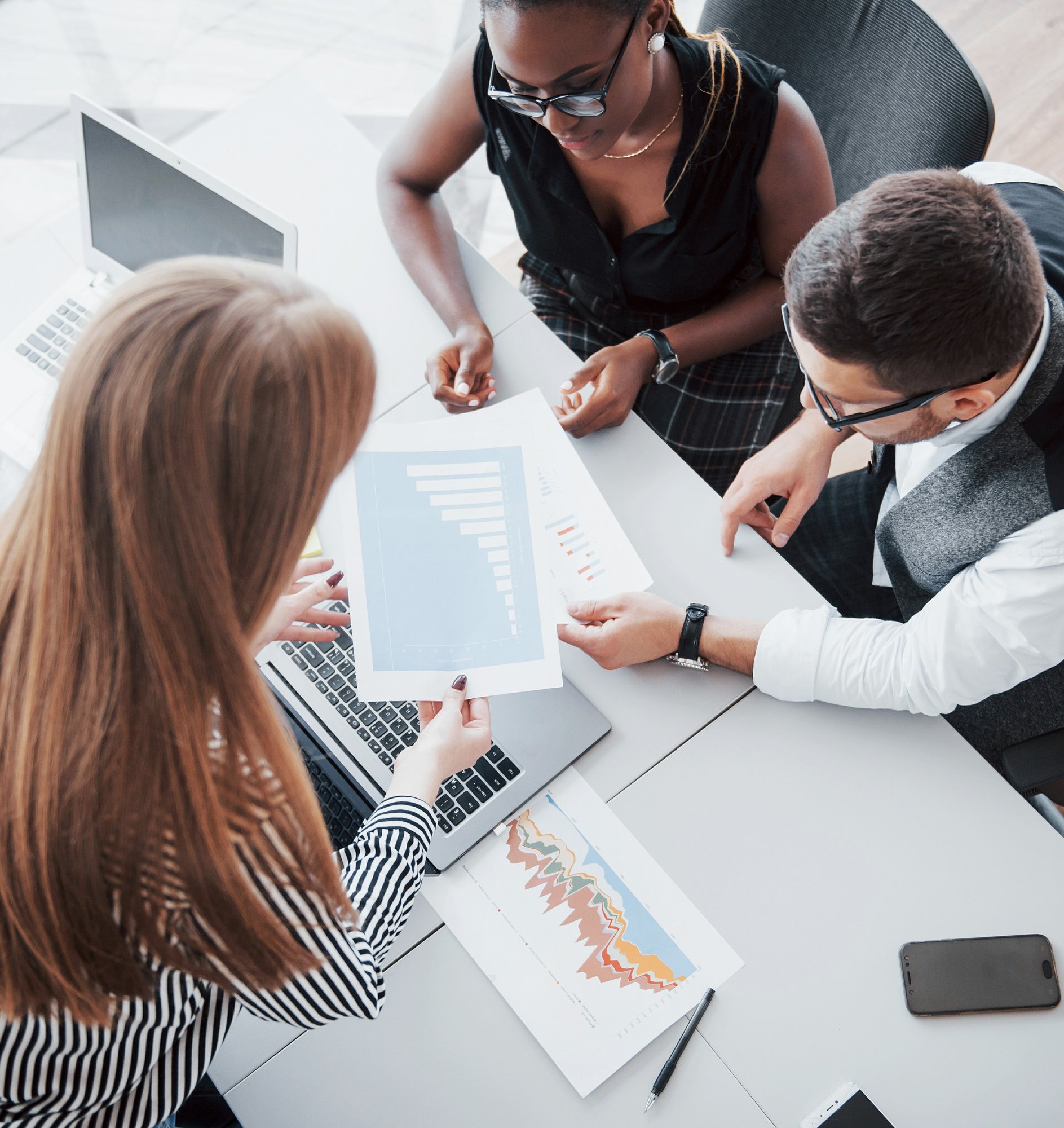 young-employees-sitting-in-the-office-at-the-table-and-using-a-laptop-a-team-work-brainstorming-meeting-concept(1)